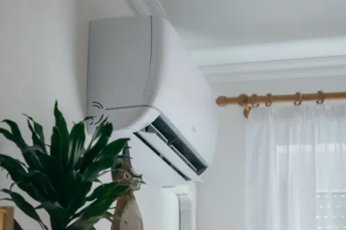 Ductless mini-split unit mounted high on a living room wall