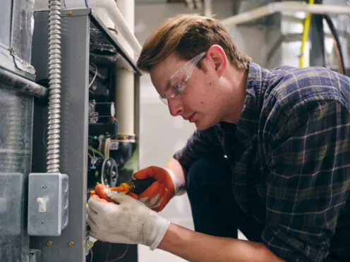 Technician servicing a home furnace